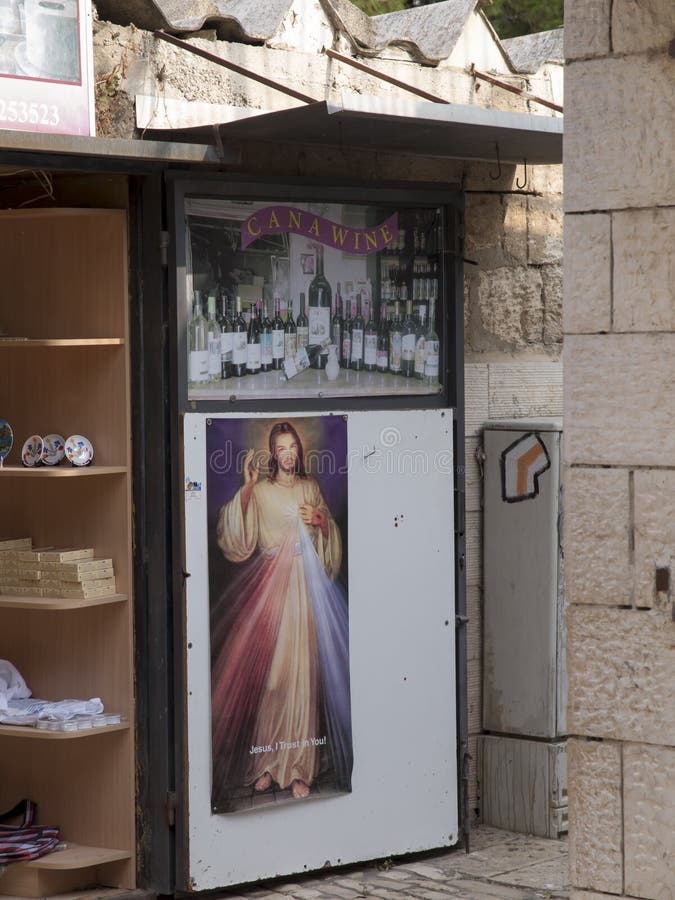 Cana, Israel, 8 July 2015: Poster of the Merciful Jesus in the shop with wine in front of the church of Jesus ` first miracle. stock photography Cana, Israel, 8 July 2015: Poster of the Merciful Jesus in the shop with wine in front of the church of Jesus ` first miracle. stock photography