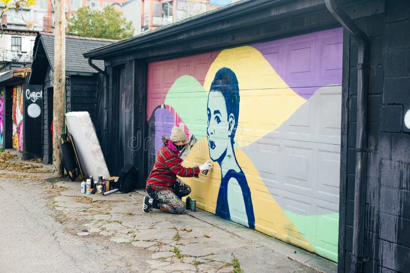 Canada, Toronto December, 2019 Graffiti Artist Spraying the Wall
