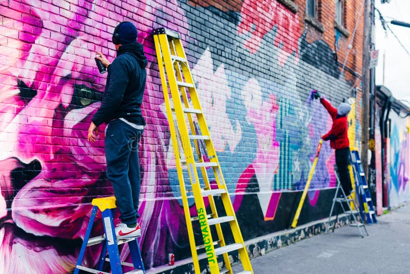 Canada, Toronto December, 2019 Graffiti Artist Spraying the Wall