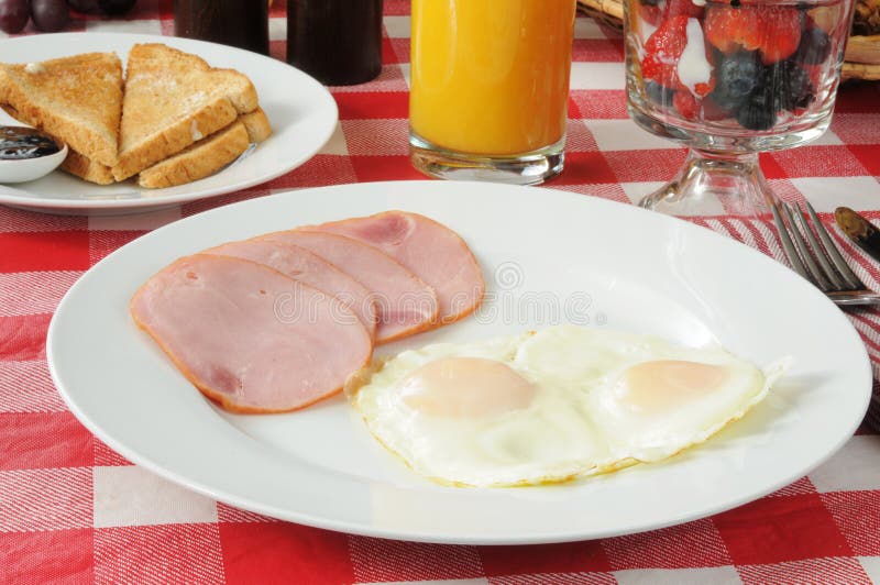Canadian bacon breakfast with fruit cocktail royalty free stock images