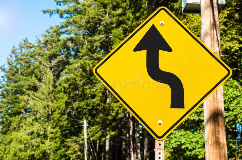 Canadian Traffic Sign along a a Forest Road with Curves