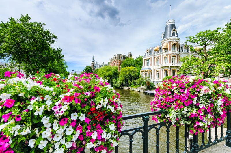Canal in Amsterdam with flowers on a bridge