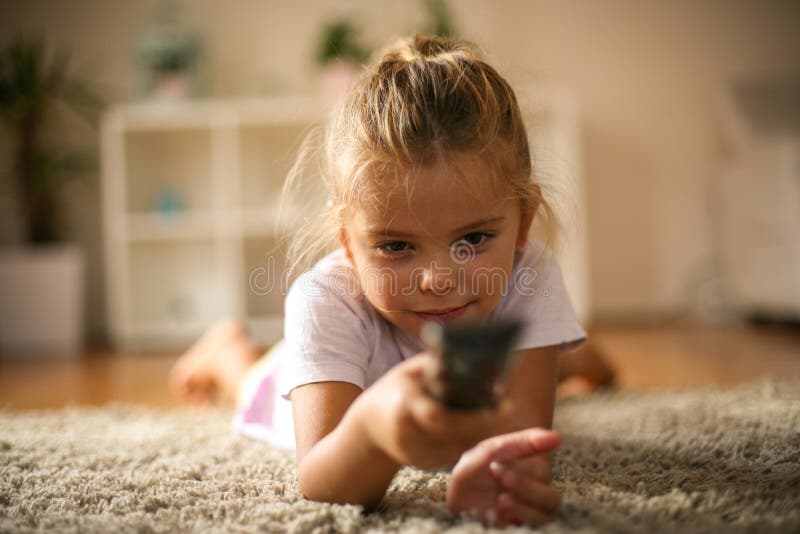 Canale televisivo cambiante della bambina con la ripresa esterna fotografia stock Canale televisivo cambiante della bambina con la ripresa esterna fotografia stock