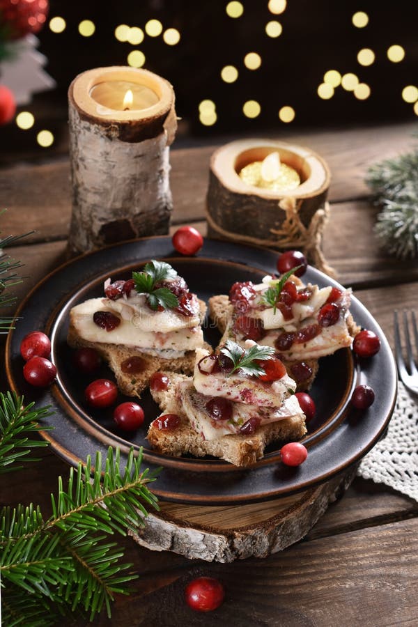 Star shaped canapes with herrings in oil and dried cranberries for Christmas. Star shaped canapes with herrings in oil and dried cranberries for Christmas