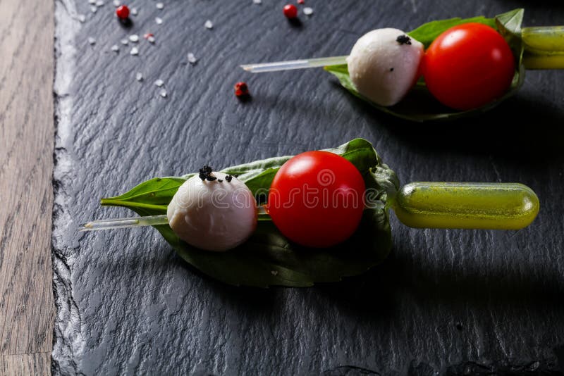 Canape caprese with oil stock photo. Image of plate - 124153484