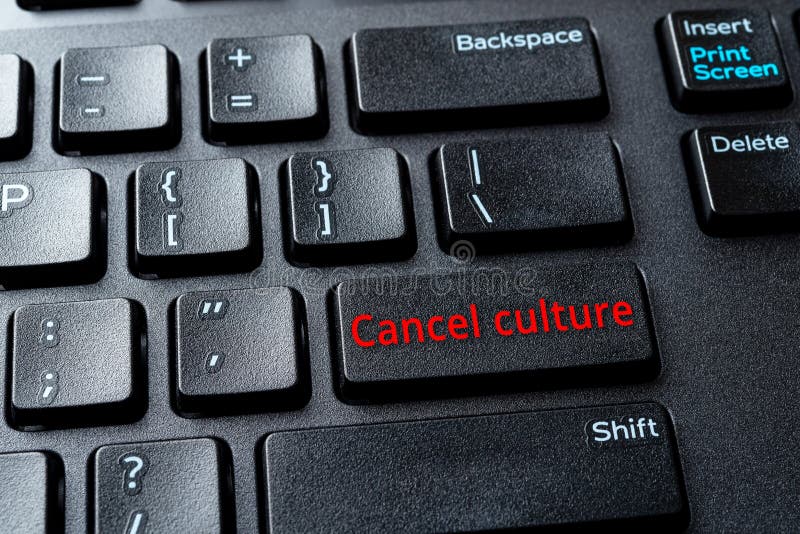 Cancel culture enter key on the black pc keyboard. Concepts of ostracism and call-out culture in the Internet and on social media