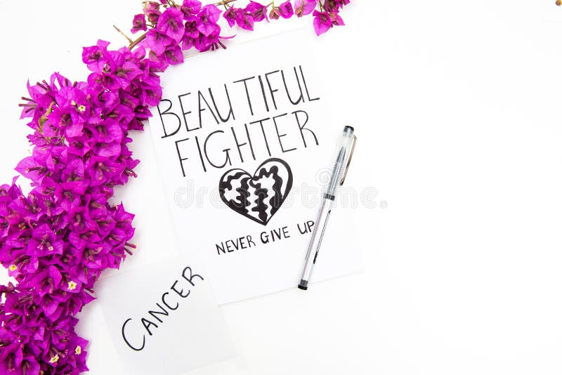 Cancer word written on note with pen and wild purple flowers. Beautiful fighter inspirational card. royalty free stock photos Cancer word written on note with pen and wild purple flowers. Beautiful fighter inspirational card. royalty free stock photos