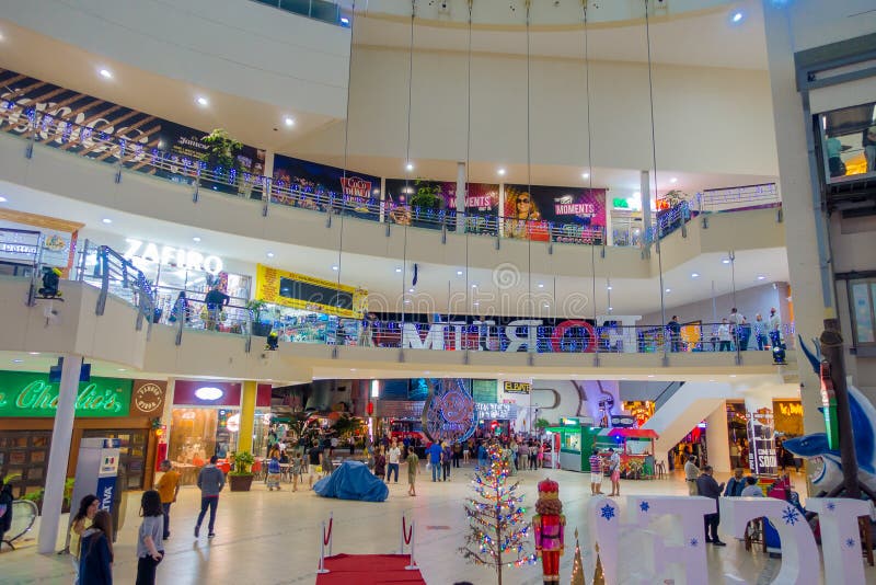CANCUN, MEXICO - JANUARY 22, 2015: Beautiful indoor view of unidentified people walking inside of The Forum in the royalty free stock images CANCUN, MEXICO - JANUARY 22, 2015: Beautiful indoor view of unidentified people walking inside of The Forum in the royalty free stock images