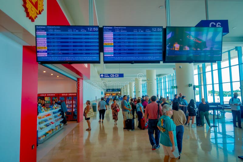 CANCUN, MEXICO - NOVEMBER 12, 2017: Unidentified people walking under an informative sign of departures, located at the