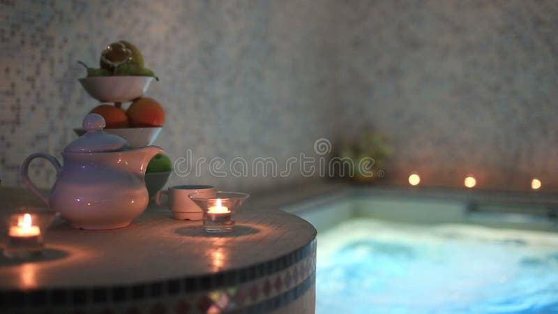 Candels tea and fruits in sayna pool romantic still life