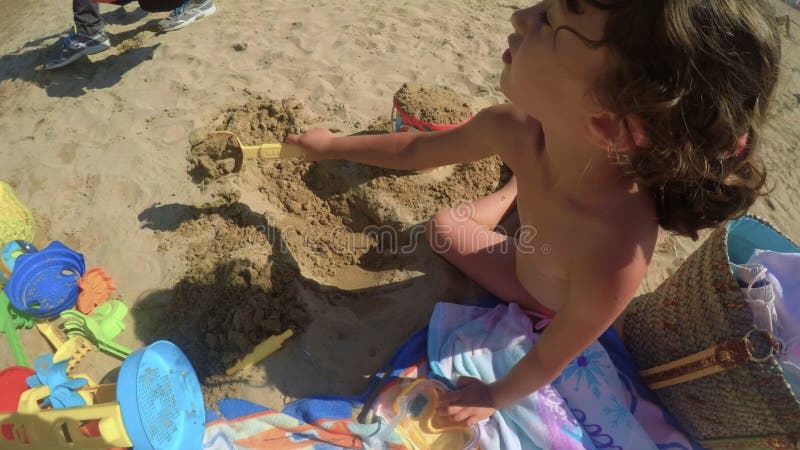 A Candid Child is Playing on the Beach with Bucket and Spade 2 FDV Stock Video - Video of vacation, summer: 143620507 