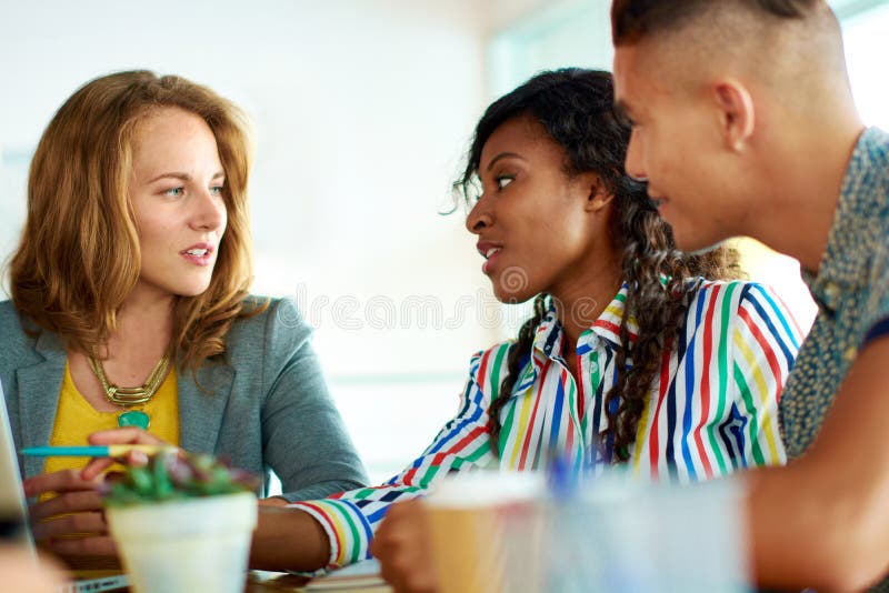 Candid image of a group with succesful business people caught in an animated brainstorming meeting royalty free stock photos Candid image of a group with succesful business people caught in an animated brainstorming meeting royalty free stock photos