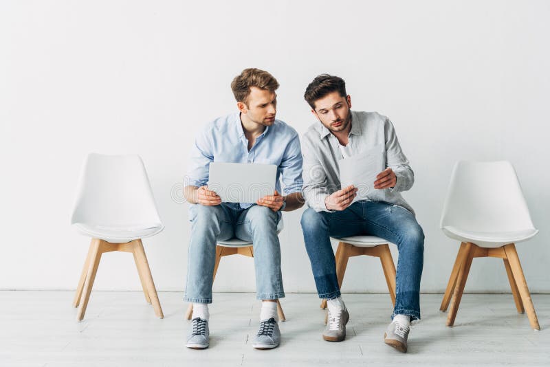 Candidates with Laptop Looking at Resume while Waiting for Job ...