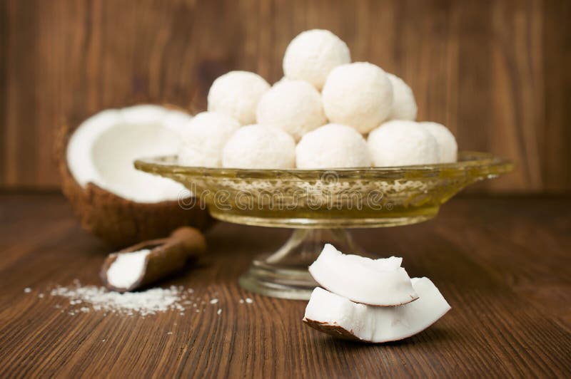 Candies in coconut flakes and fresh coconut stock photos Candies in coconut flakes and fresh coconut stock photos