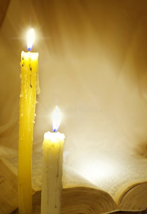 Holy bible and burning candles royalty free stock image