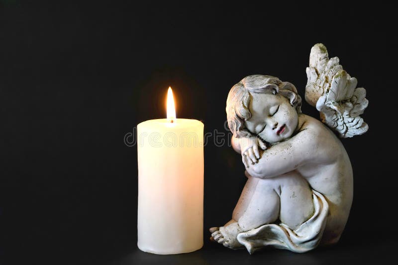 Candle and angel figurine