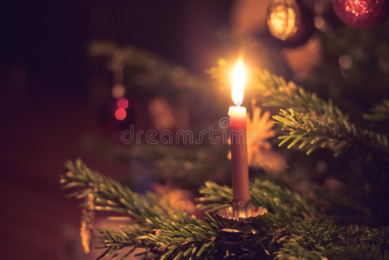 Candle on Traditional Decorated Christmas Tree, Evening Stock Image