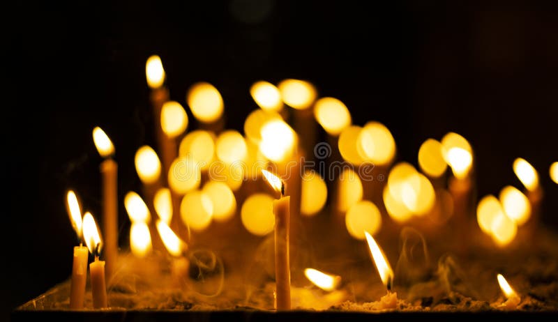 Candle fire yellow illumination flame in christian church darkness space spiritual atmosphere concept background picture divine. Worship time stock image Candle fire yellow illumination flame in christian church darkness space spiritual atmosphere concept background picture divine. Worship time stock image