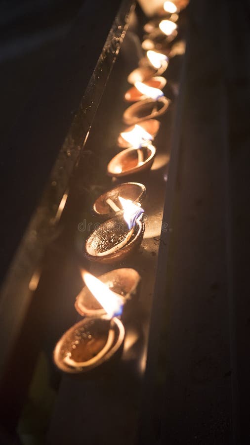 Candle flame close-up. Many Candles in a Buddhist temple. Religious Festival. Oil Lamp royalty free stock photography Candle flame close-up. Many Candles in a Buddhist temple. Religious Festival. Oil Lamp royalty free stock photography