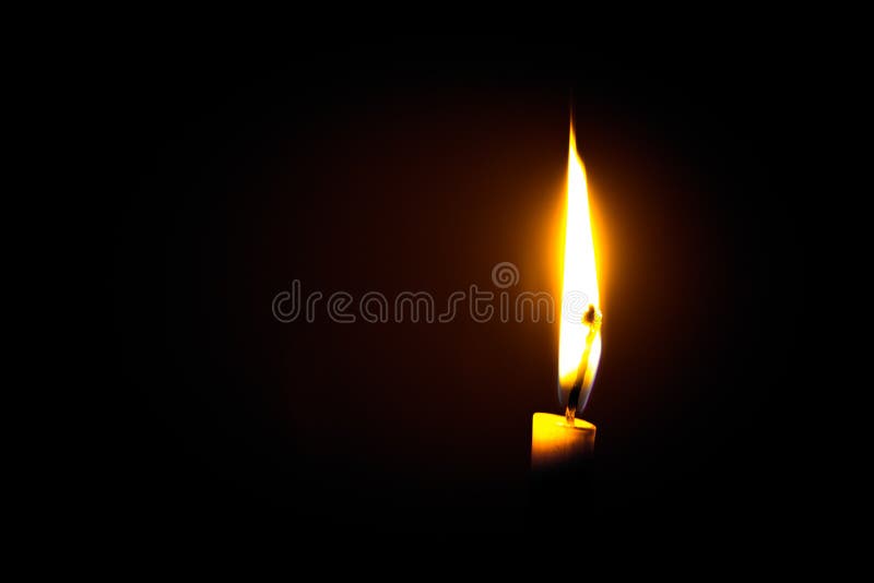 A flame from a candle at dark night background. A flame from a candle at dark night background.