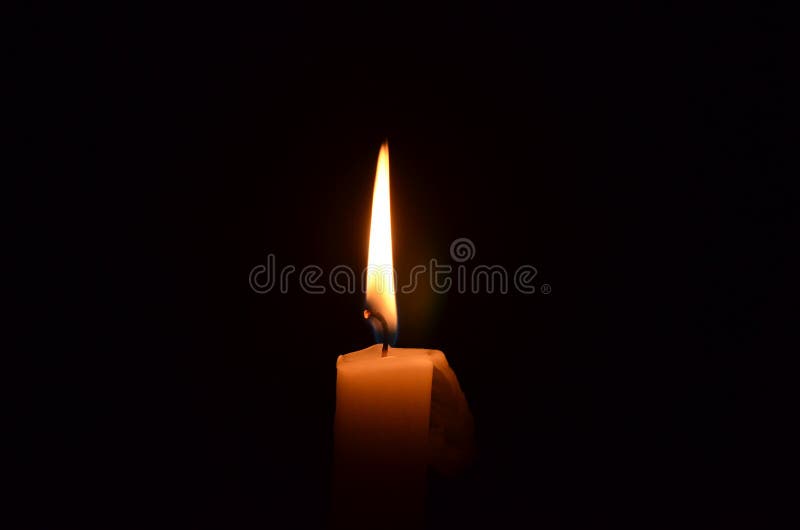 Flickering candle flame on a black background