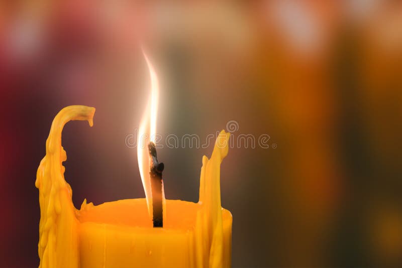 Candle in front of many defocused candleflames creating a spirit stock photos Candle in front of many defocused candleflames creating a spirit stock photos