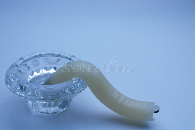 The Candle in a Glass Stand from the Heat Changed Its Shape Stock Photo