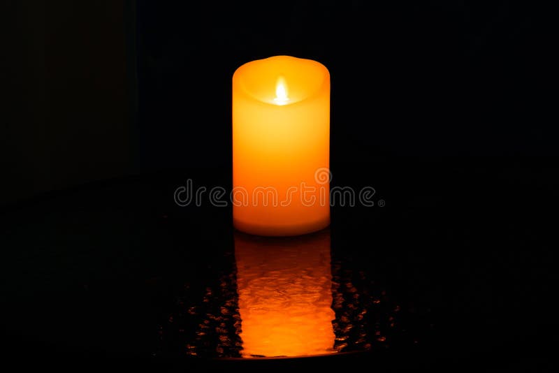 Candle Light Orange with a Black Background Stock Photo Image of hope
