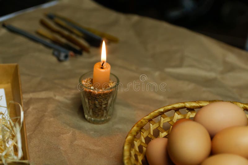 Candle with Light. Rustic Background. Tools for Decorating Paschal Eggs