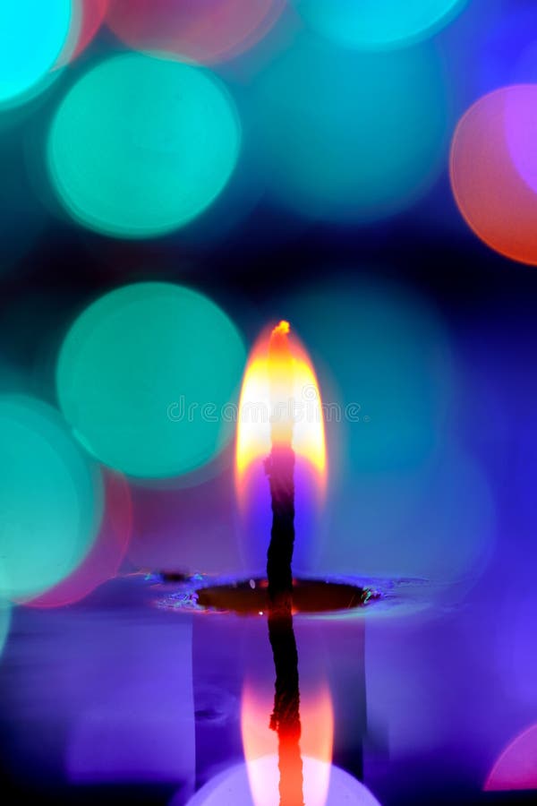 Candle Light in the Water in the Pool on the Twilight. Stock Photo