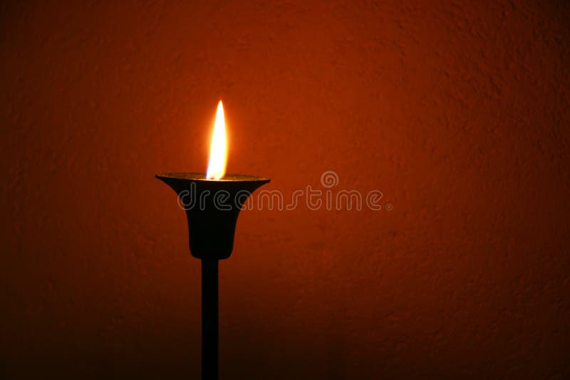 Candle over red wall