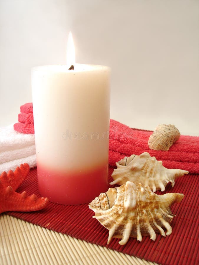 Candle, towels and seashells