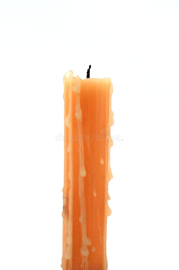 A yellow candle standing with a white background. A yellow candle standing with a white background