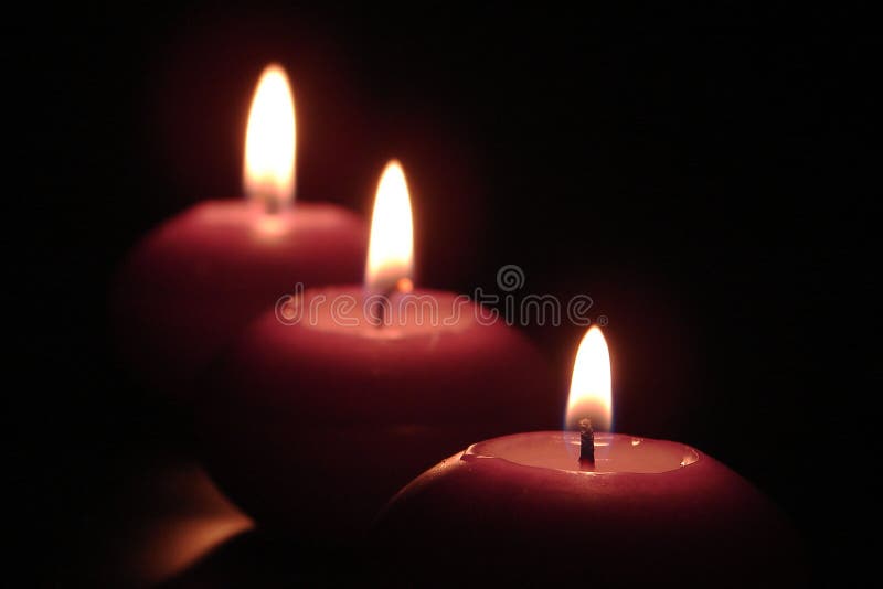 3 candles in a row burning in the dark. Lit fires stock images, royalty-free photos and pictures