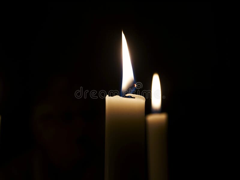 Candles burning in darkness stock photo