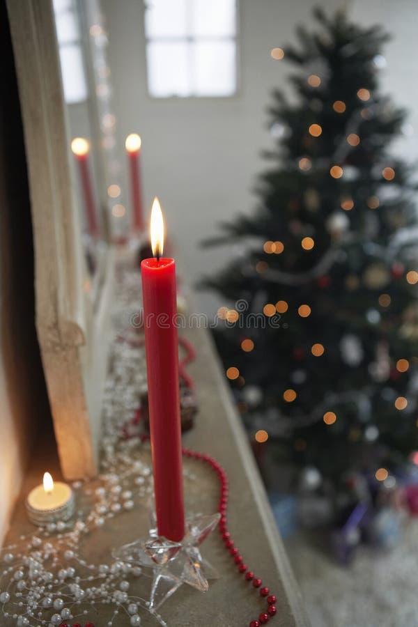 Candles Burning On Mantelpiece On Christmas Day