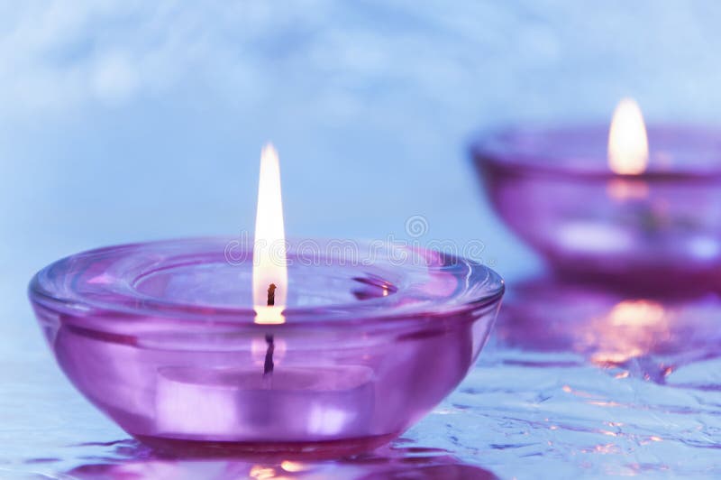 Candles in Candlesticks on a Metallic Background in Purple Stock Photo