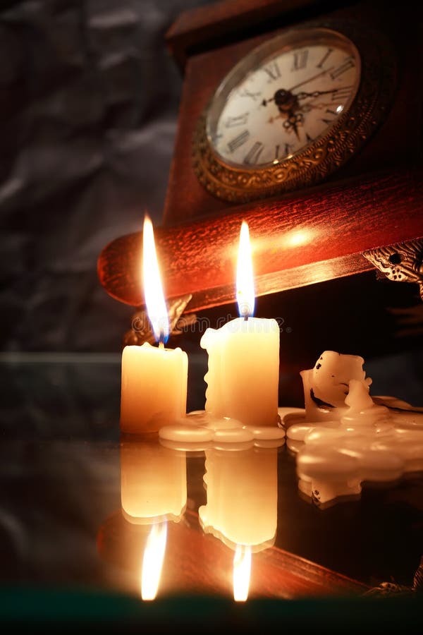Candles Near Clock stock photo. Image of indoor, evening 103122100