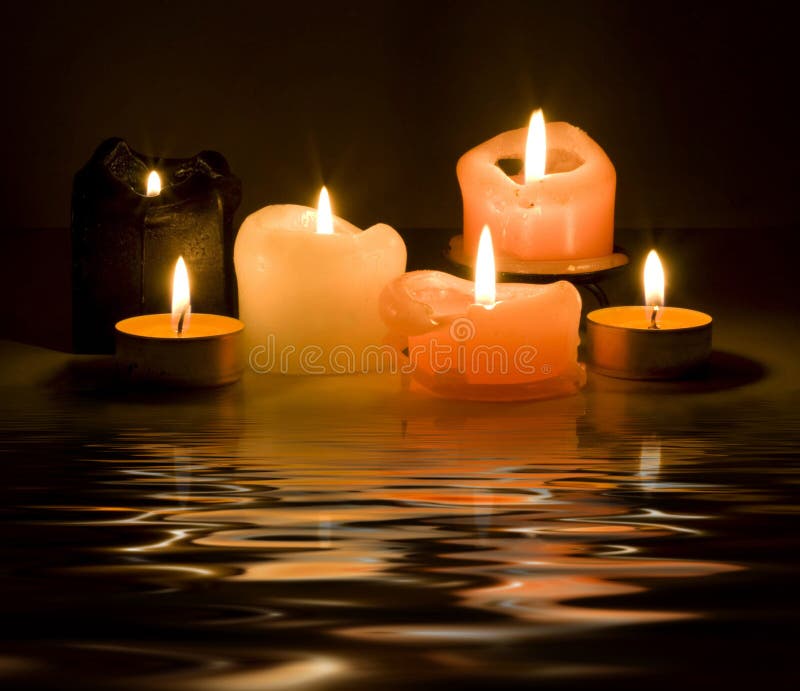 Candles and reflection on a dark background. Metallic colored stock images, royalty-free photos and pictures
