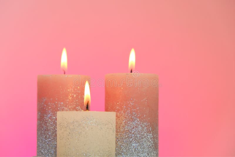 Candles Set. Festive Glitter Candles on a Pink Background. Candle Flame