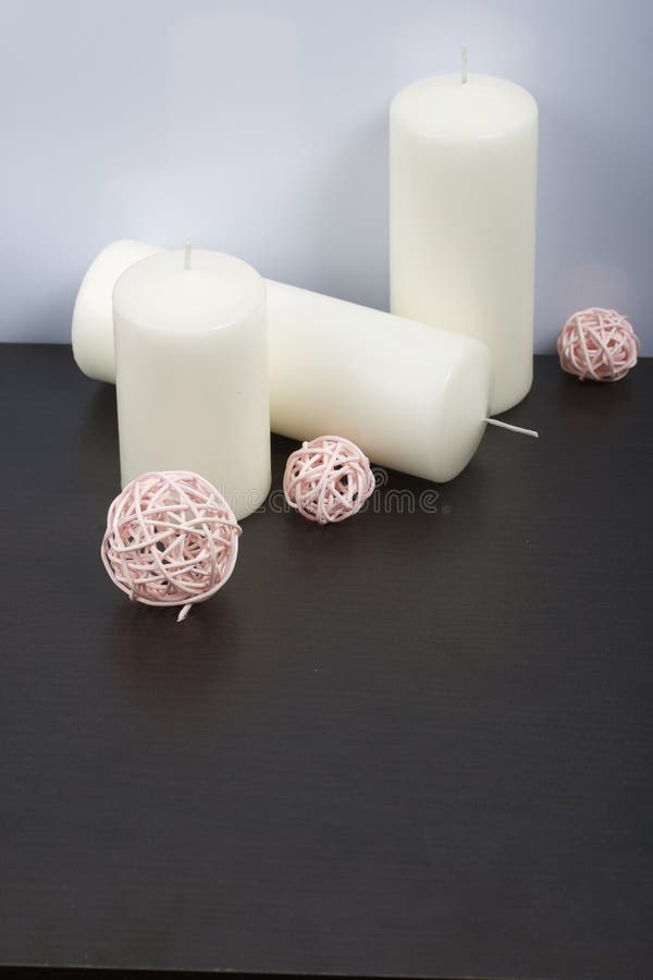 Candles White in Color among the Decorative Balls, Woven from Natural Materials Stock Photo