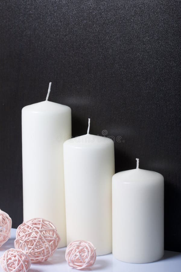 Candles White in Color among the Decorative Balls, Woven from Natural