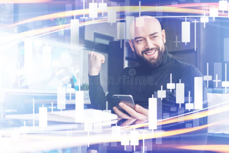 Candlestick chart in foreground. In background bearded man holds smartphone and is emotionally happy about winning royalty free stock photos