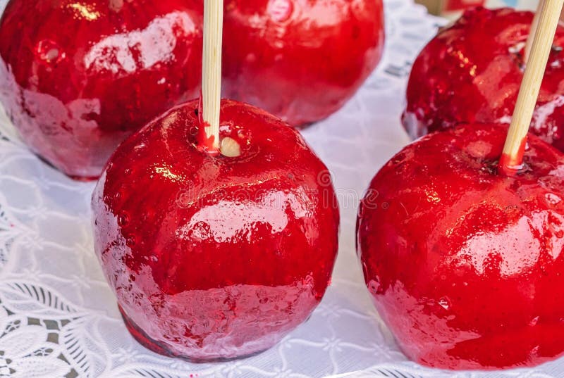 Candy Apple or Taffy Apple Red Caramelized Apples on a Stick Stock