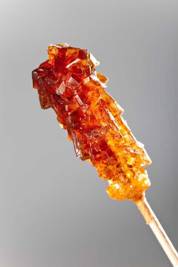Candy Brown Sugar on a Stick Lies on White Sugar Stock Image Image of