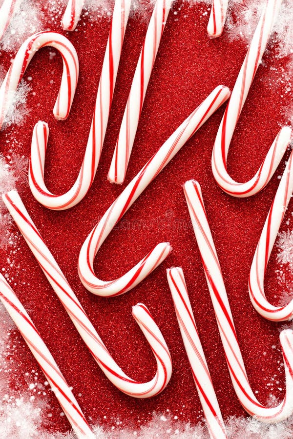 Candy cane on a red, shiny background. Winter new year royalty free stock photos Candy cane on a red, shiny background. Winter new year royalty free stock photos