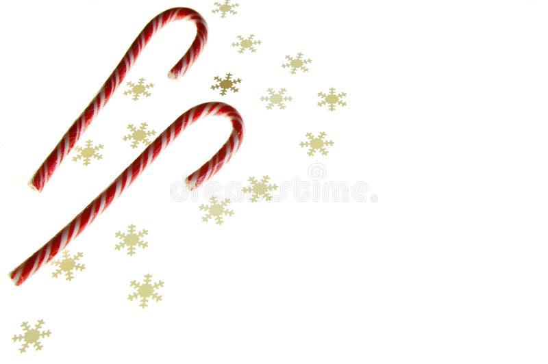 Candy canes and snowflake confetti a white background. Candy canes and snowflake confetti a white background