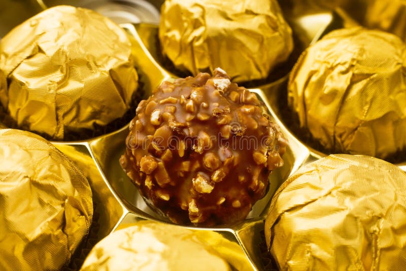 Candy in gold wrappers, stock photo. Image of round 105529426