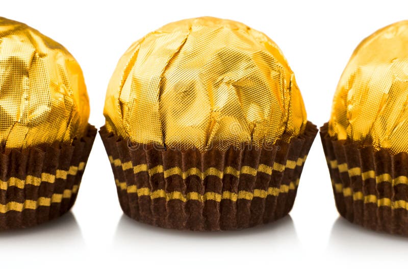 Candy in gold wrappers, stock photo. Image of round 105529426