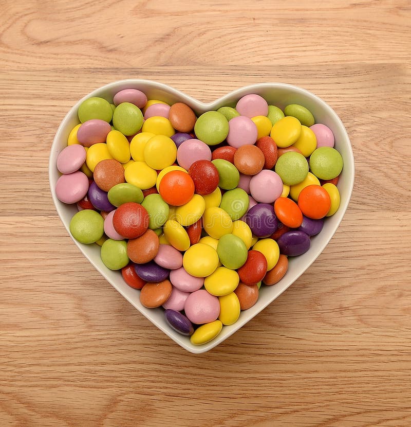 Candy in heart shaped bowl stock photo. Image of colorful 37615642